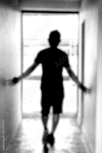blurred background of a guy walking through tunnel toward the light, concept of light at the end of the tunnel, never giveup
