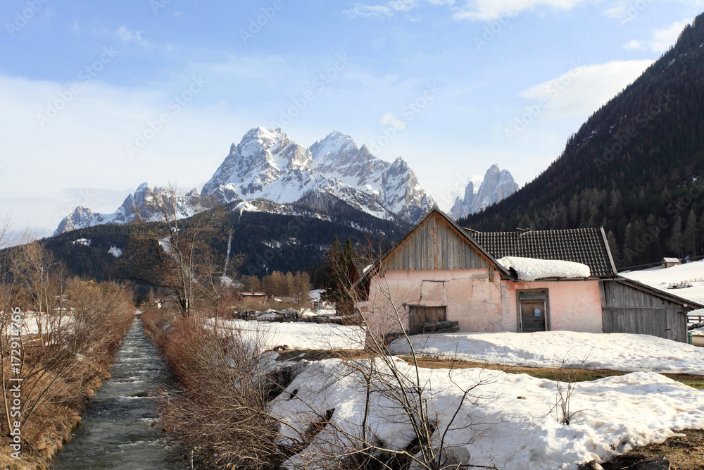 snowy landscape of village at Dolomites alps, Italy