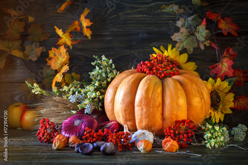 The wooden table decorated with vegetables  pumpkins and autumn leaves. Autumn background. Schastlivy von Thanksgiving Day.