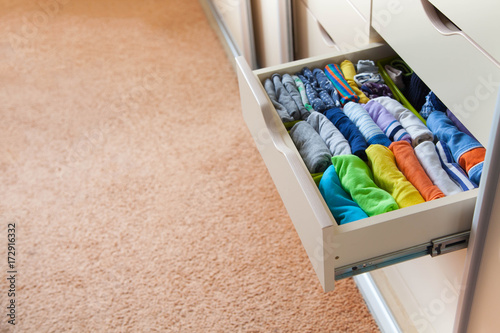 Closet with children's things. Storage of children's clothes. photo