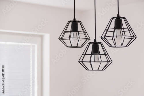 Suspended chandelier in loft style in a modern house interior.