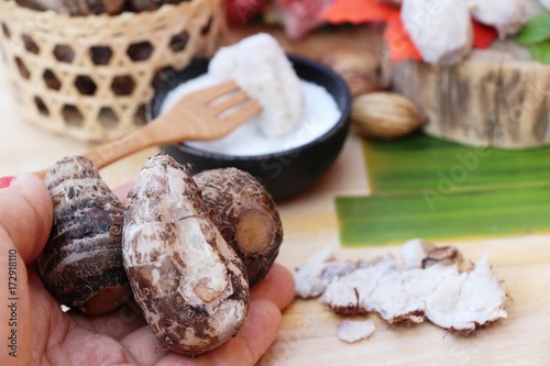 Boiled taro with sugar on wood background