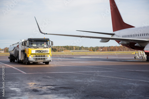 Truck Moving By Airplane On Runway photo