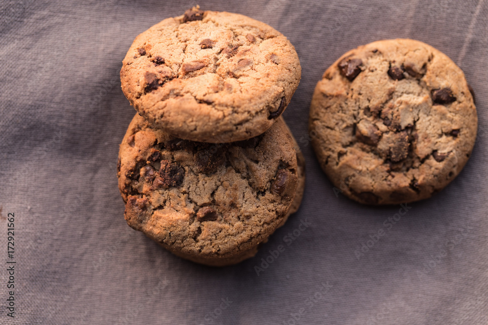 Stack of chocolate chips cookies on brown background Stack of chocolate chips cookies on brown background