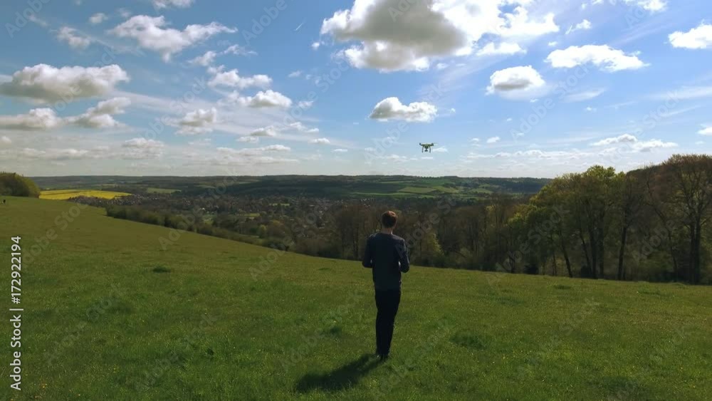 Aerial Shot Of Man Flying Drone Over Countryside Aerial Shot Of Man Flying Drone Over Countryside