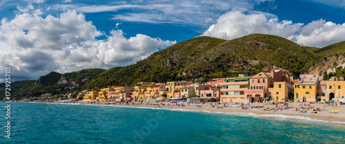 Panoramic view of Varigotti, small sea village near Savona, with crowded beach during a sunny afternoon