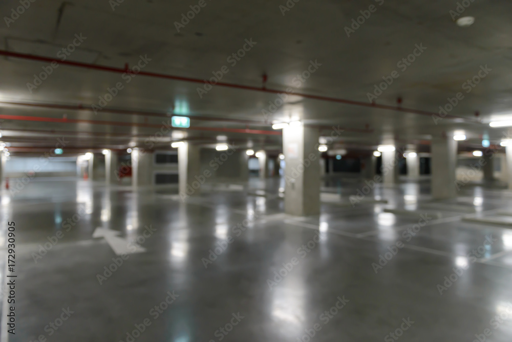 Blurred image of empty underground cars parking.