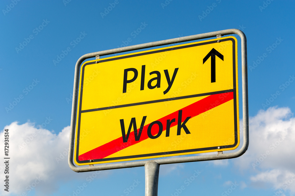 Yellow street sign with Play ahead leaving Work behind Yellow street sign with Play ahead leaving Work behind