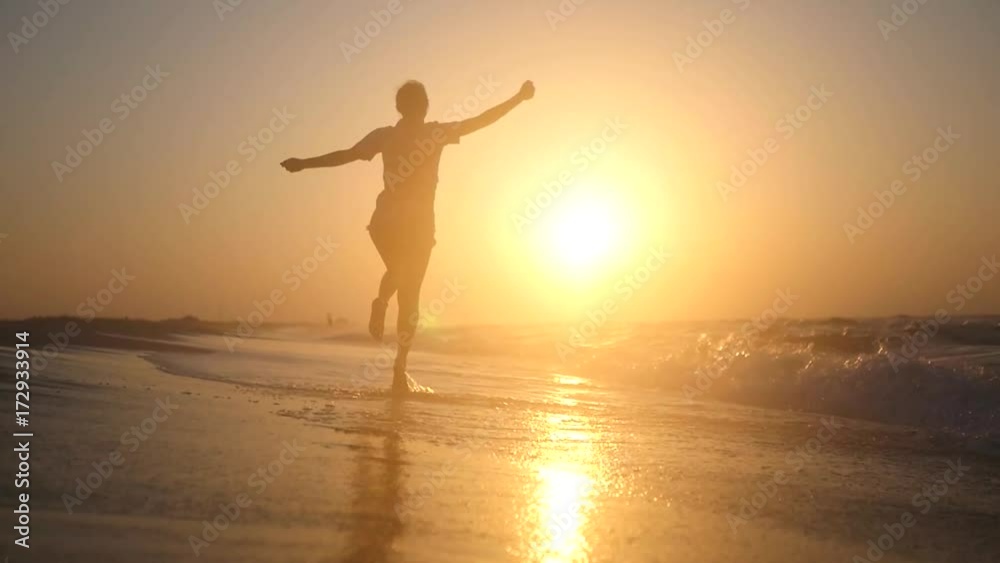 Happy little girl joyfully jumps on the beach near the sea waves on the golden sunset. HD, 1920x1080. slow motion. Happy little girl joyfully jumps on the beach near the sea waves on the golden sunset. HD, 1920x1080. slow motion.