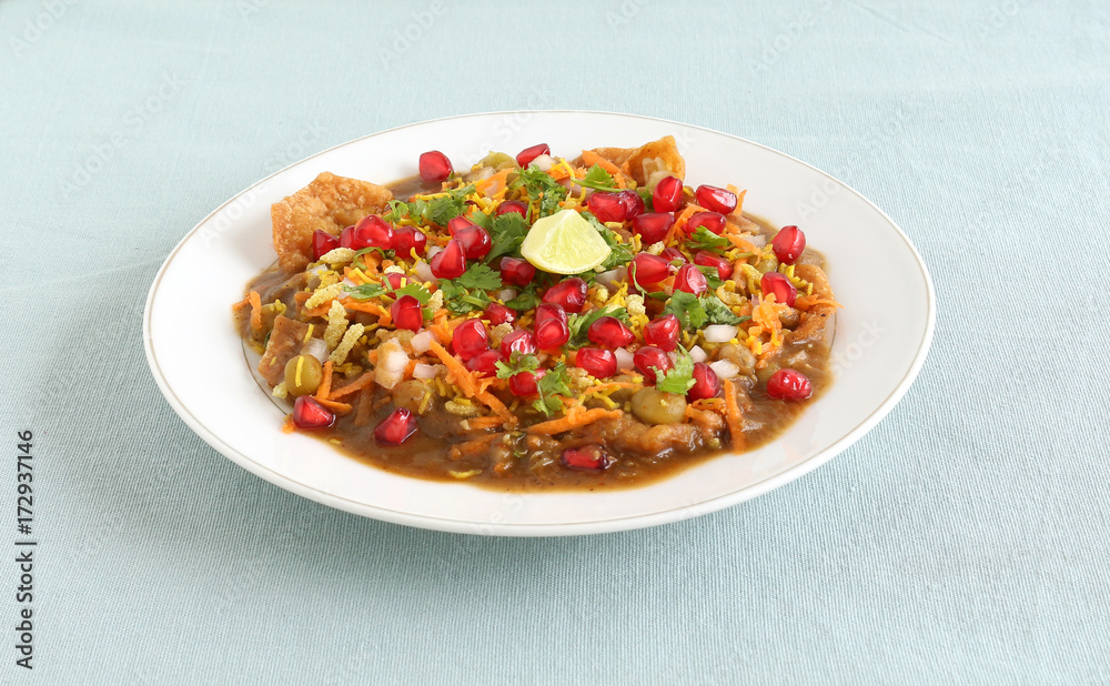 Masala puri, a popular street food of India, is made by mixing ingredients like puri and tamarind and coriander chutney, peas gravy, cooked peas, onion, carrot, pomegranate and coriander leaves. Masala puri, a popular street food of India, is made by mixing ingredients like puri and tamarind and coriander chutney, peas gravy, cooked peas, onion, carrot, pomegranate and coriander leaves.