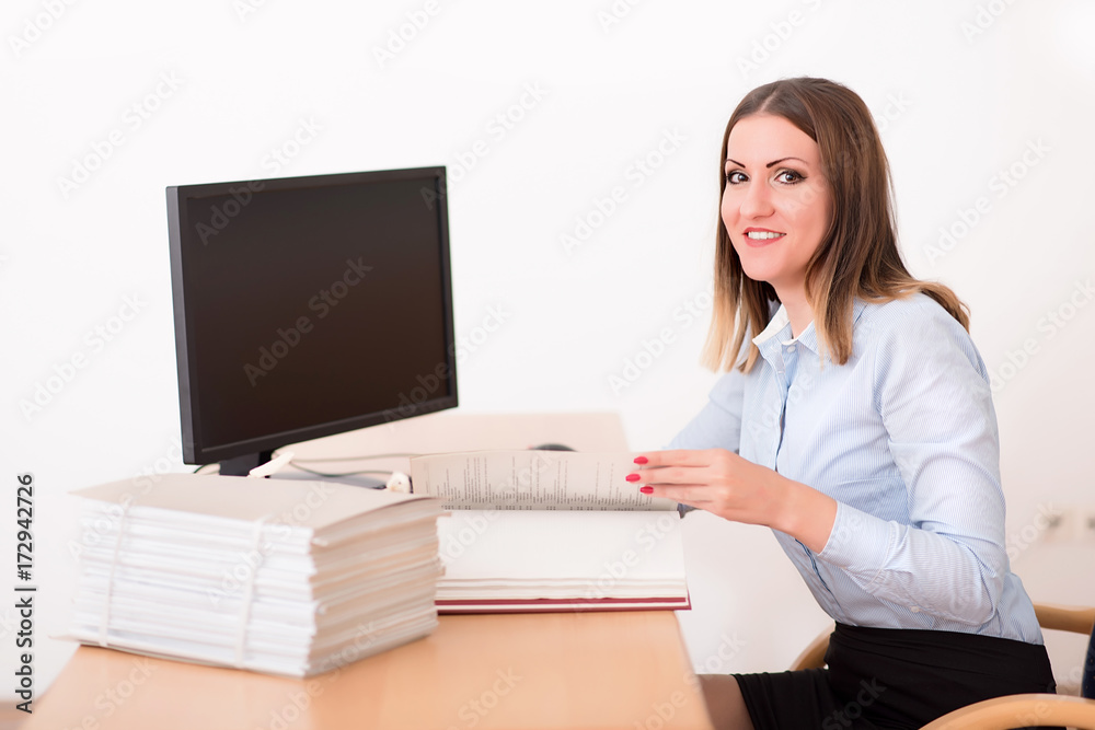 Woman reading a document in the office Woman reading a document in the office