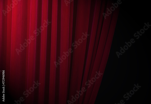 Red curtains at a theatre with half light for text or other ideas  