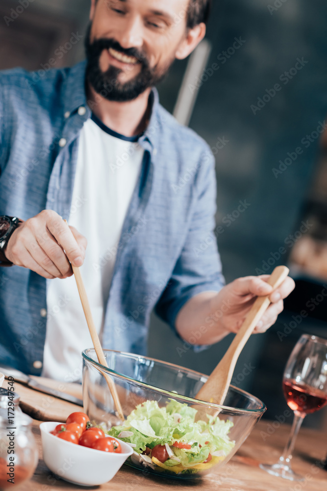man cooking salad