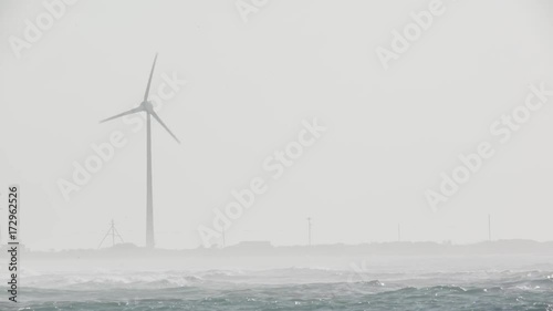 A windwill on the island of bonaire, ocean in front. photo