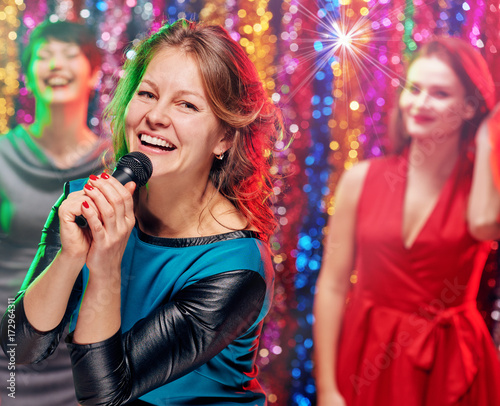 Smiling singing woman in karaoke