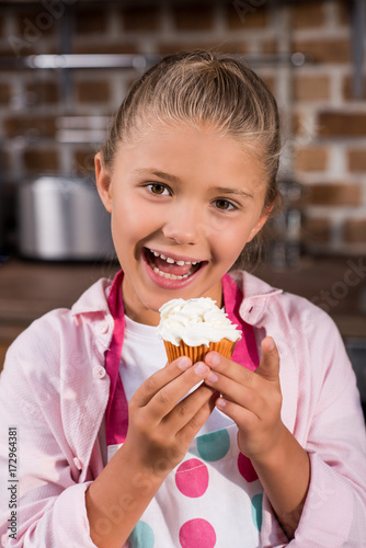 child with sweet cupcake