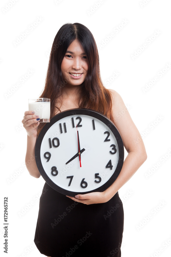 Healthy Asian woman drinking glass of milk hold clock. Healthy Asian woman drinking glass of milk hold clock.