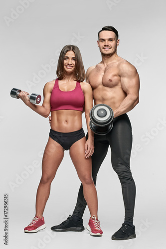 Man and woman with dumbbells