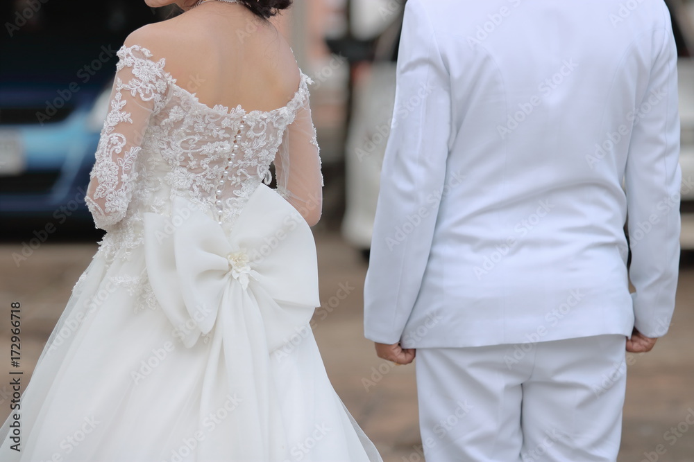 Back view of groom and bride waiting guest in wedding ceremony. Couple love and romance concept. Back view of groom and bride waiting guest in wedding ceremony. Couple love and romance concept.