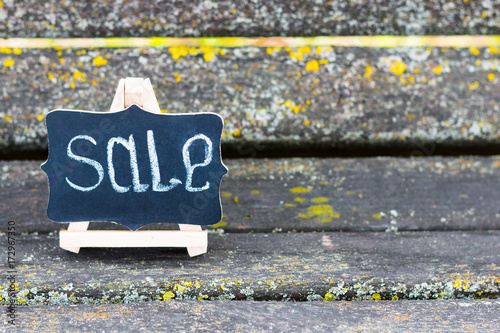 A small wooden malbert with a slate on which chalk is written 