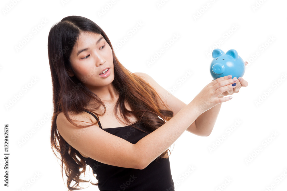 Young Asian woman with a pig coin bank. Young Asian woman with a pig coin bank.