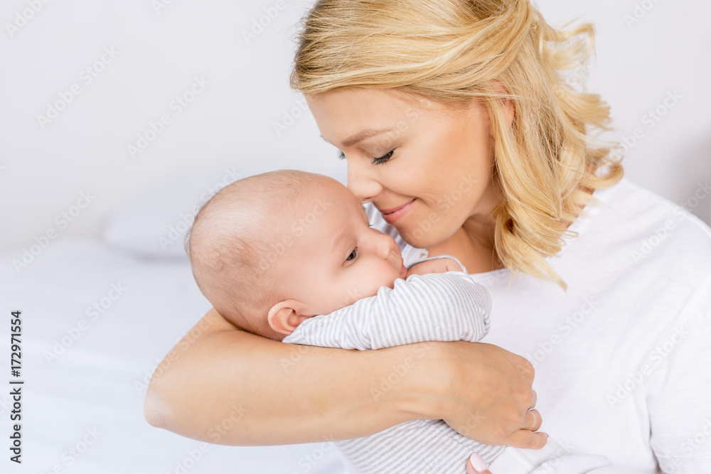 mother holding infant mother holding infant