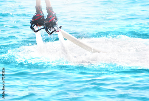 Flyboarding and seariding in a sunny summer day photo
