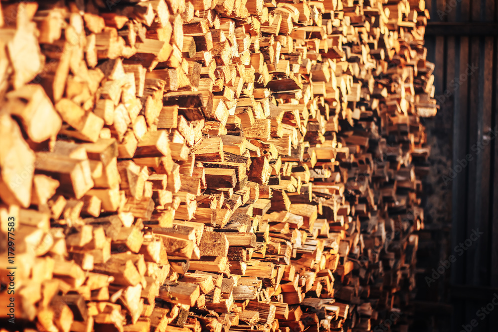 Natural wooden background, closeup of chopped firewood. Firewood stacked and prepared for winter. Pile of wood logs. Chopped firewood on a stack. Natural wooden background, closeup of chopped firewood. Firewood stacked and prepared for winter. Pile of wood logs. Chopped firewood on a stack.