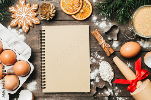 Xmas baking or cooking background. Ingredients, kitchen items for baking cookies. Kitchen utensils, flour, eggs and sugar. Text space, top view.