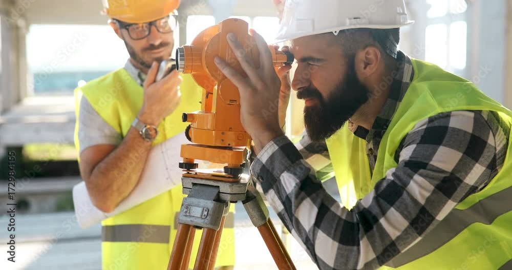 Portrait of construction engineers working on building site