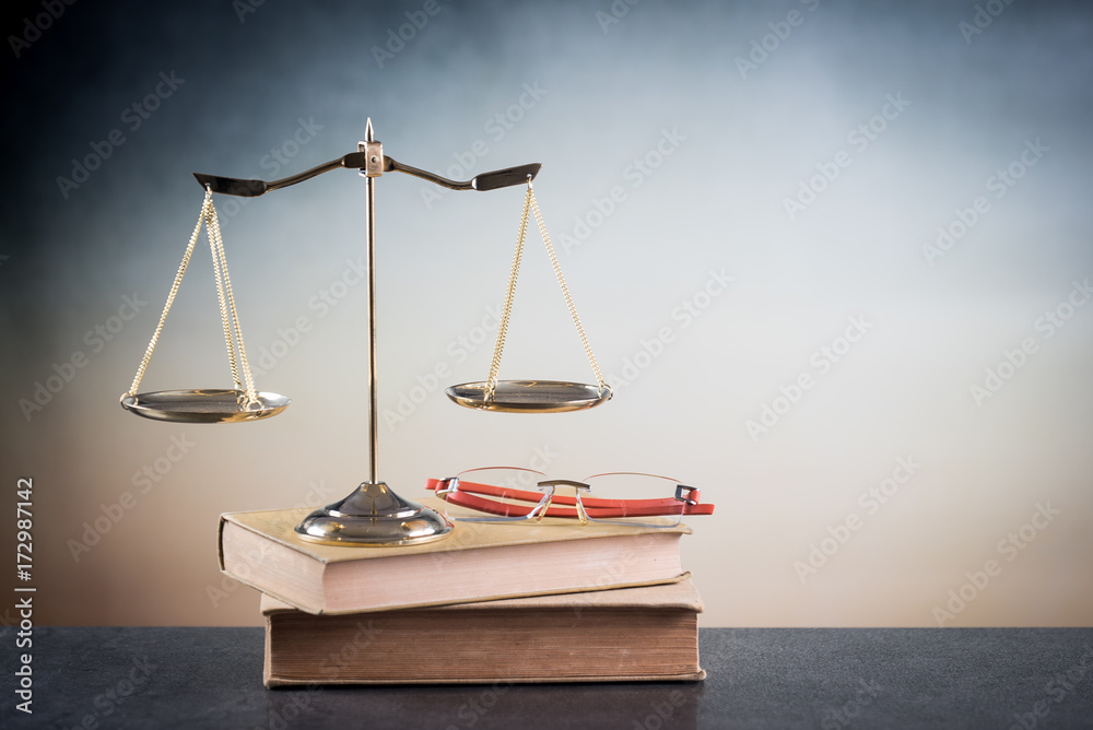 Justice scale and  glasses on the book