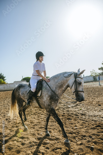 Young woman riding on horse
