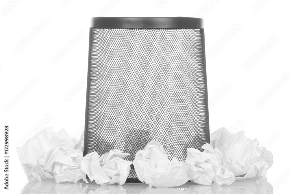 Black empty basket for paper waste bottom up and around balls of