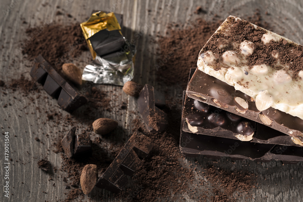 Milk and dark chocolate on a wooden table