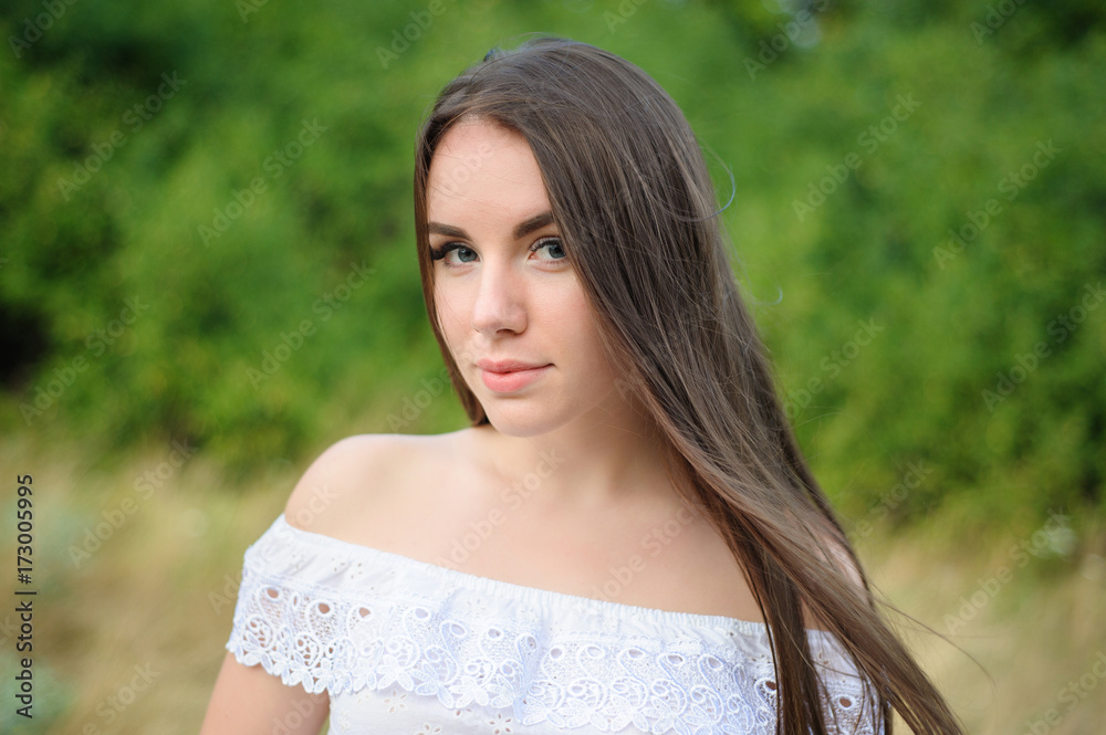 portrait of a young beautiful girl in a park in white dress portrait of a young beautiful girl in a park in white dress