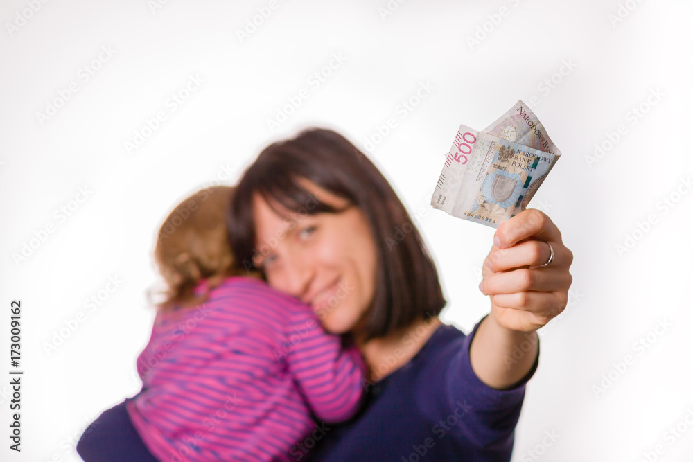 Mother with little daughter holds in hand 500 zloty banknote. Symbol of 500 + polish program for families.