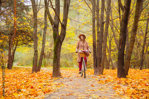 travel concept young woman with bicycle picnic set in bright autumn city park  © Alena Popova