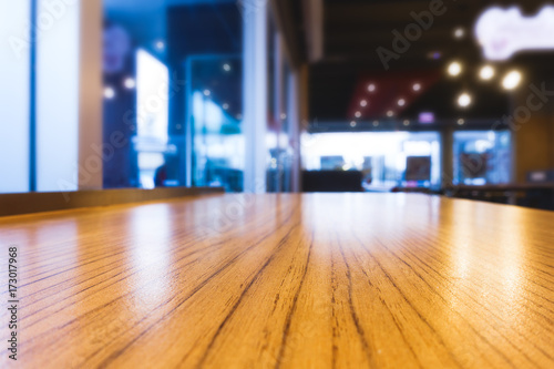 Empty table top with blurred restaurant or coffee shop background for product display