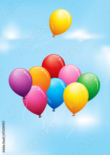 Colourful balloons floating in a cloudy sky
