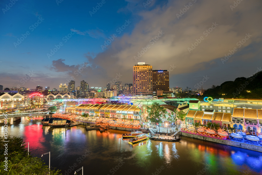 Obraz premium Colorful light building at night in Clarke Quay, Singapore. Clarke Quay, is a historical riverside quay in Singapore.