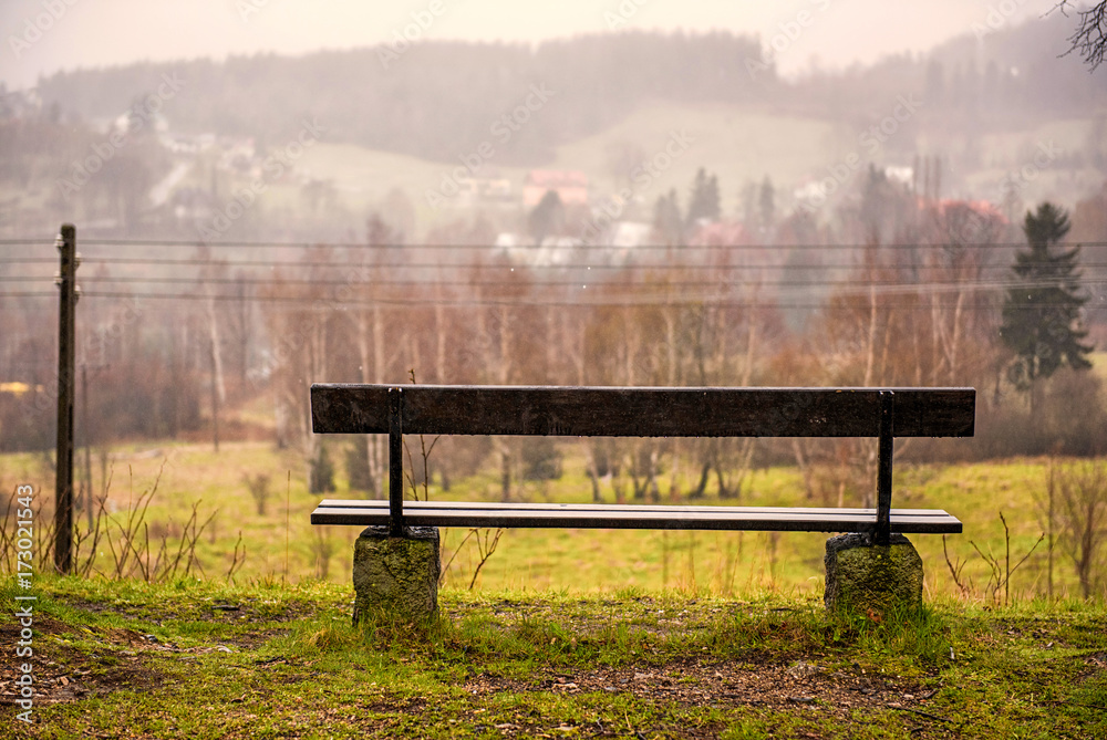 Old wooden bench in a rainy and foggy day in mountains. Eternal autumn. Fall. Autumn mood Old wooden bench in a rainy and foggy day in mountains. Eternal autumn. Fall. Autumn mood