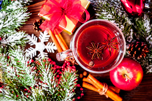 cup with christmas mulled wine on wooden background top view