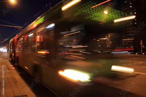 The motion of a blurred bus in the street in the evening