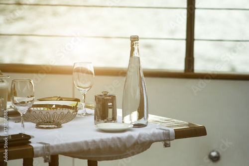 Wallpaper Mural table on the ship with a glass and a bottle of water Torontodigital.ca