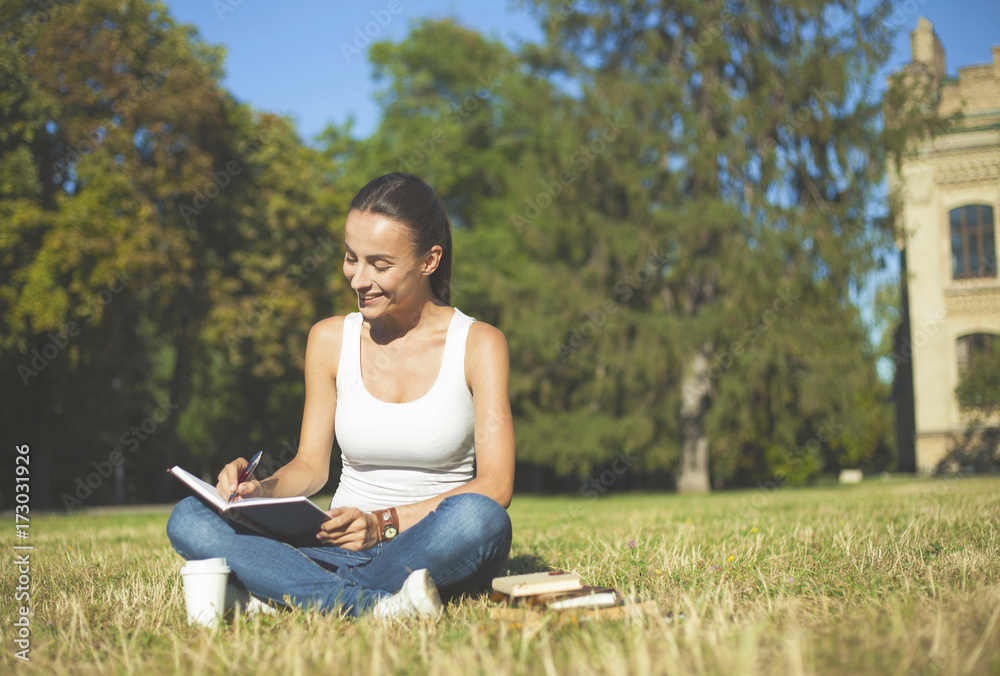 Student girl preparing for lessons near university building. Student girl preparing for lessons near university building.