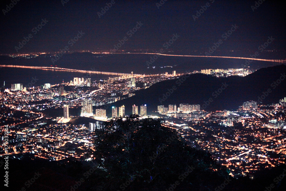 Amazing Cityscape Penang downtown at night, from the top of view on skyscraper, show lighting on the road of communication concept.
