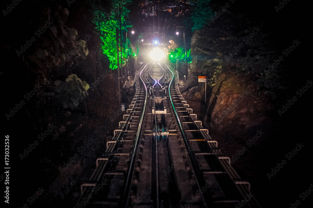 Naklejka premium Modern driver-less metro train rush forward, along night Malaysia, bright road lights at night.