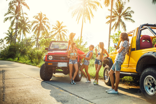 group of friends enjoying vacation on koh samui thailand in jungle with trucks photo