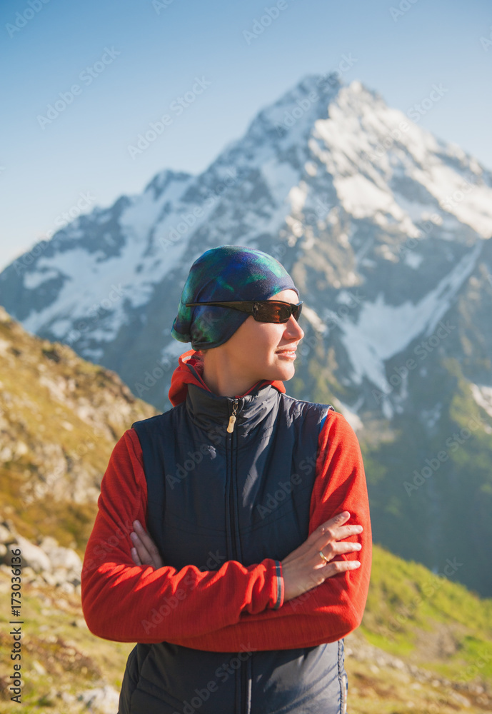 Tourist woman hiker on the mountains background