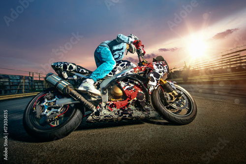 Fototapeta Naklejka Na Ścianę i Meble -  Moto rider making a stunt on his motorbike. Biker doing a difficult and dangerous stunt.